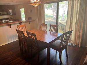 a wooden table and chairs in a kitchen with a window at Golfside Vacation Home 2 in Bella Vista