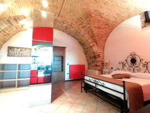 a bedroom with a bed in a brick wall at Assisi Garden Suite in Assisi