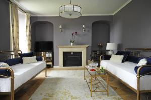 a living room with two beds and a fireplace at Topside House - Beautiful 7 bedroom house with hottub wifi and parking near Bath Wells Frome in Oakhill