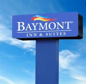 a blue sign for a baymont inn and suites at Baymont by Wyndham Hannibal in Hannibal