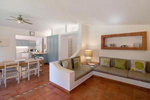 a living room with a couch and a dining room at Quinta da Balaia in Albufeira