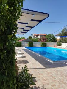 a swimming pool in a villa with a blue swimming pool at Anesis Village Studios and Apartments in Lygia