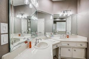 a bathroom with two sinks and a large mirror at Horseshoe Bay Beauty in Horseshoe Bay +29 photos