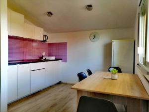 a kitchen with a wooden table and a dining room at 7 PALMI Novigrad in Novigrad Istria