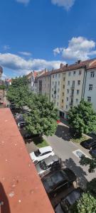 a parking lot with cars parked in front of a building at Apartment in Aufseßplatz in Nürnberg