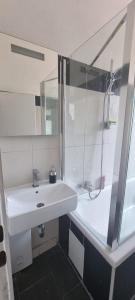 a bathroom with a white sink and a shower at Apartment in Aufseßplatz in Nürnberg +7 photos