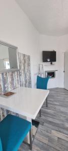 a white table and blue chairs in a room at Apartment in Aufseßplatz in Nürnberg