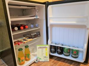 an open refrigerator with drinks in the door at HOTEL BRILLO in Puerto Maldonado