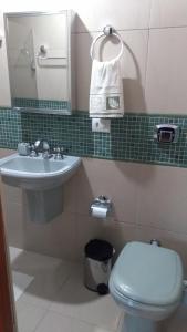 a bathroom with a sink and a toilet and a mirror at Recantto do Divino B&B in Campos do Jordão