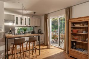 a kitchen with a counter and some chairs in it at Alma&Antonia in Schladming