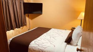Postel nebo postele na pokoji v ubytování Apple Inn Motel