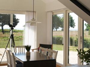 a dining room with a table and a camera at Seaside Spa Retreat - By Traum Ferienwohnungen in Hals +14 photos