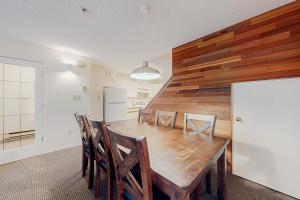 a dining room with a wooden table and chairs at Villas Foxglove in Whistler