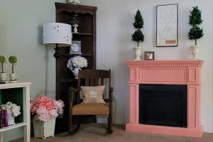 a living room with a pink fireplace and a chair at Large 1 BR Cottage, KING BED on the Lake in Paw Paw