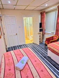 a hotel room with a large bed and a room at The Albany Hotel in Blackpool