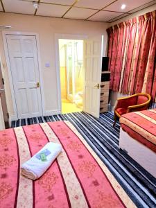 a hotel room with two beds and a chair at The Albany Hotel in Blackpool +18 photos