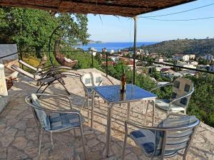 a table and chairs on a patio with a view at Apartmani Bella in Sutomore