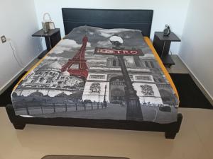 a bed with a blanket with the eiffel tower at Apartmani Bella in Sutomore