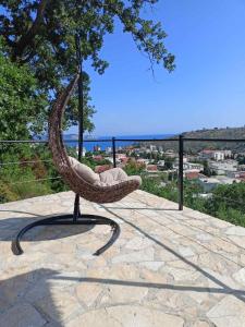 a wicker chair sitting on top of a patio at Apartmani Bella in Sutomore