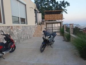 a motorcycle parked in front of a house at Apartmani Bella in Sutomore +57 photos