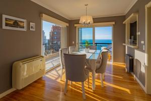a dining room with a table and chairs at Departamento Varese Güemes Alta Gama Luxury 4/5 Pax Vista Mar in Mar del Plata