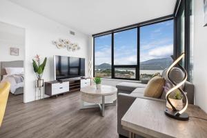 a living room with a couch and a tv at Brand New Luxury Downtown Near the Beach #15 in Kelowna