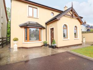 a detached house with a driveway in front of it at Millfield in Kenmare