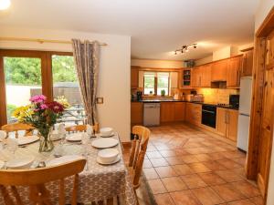 a kitchen and dining room with a table and chairs at Millfield in Kenmare