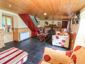 a living room with a couch and a staircase at Ceol Na N'ean in Sneem