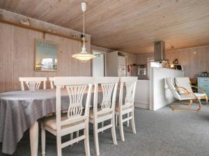 a dining room with a table and chairs at Holiday home Bogense XXXIII in Bogense
