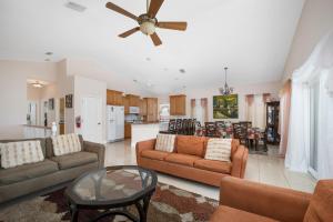a living room with two couches and a kitchen at Wave Runner, 4 Bedrooms, Sleeps 10, Ocean Front, WiFi in Flagler Beach