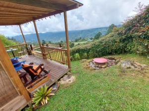 a wooden deck with a bench and a fire pit at Refugio Naturaleza en Armonia in San Francisco +23 photos