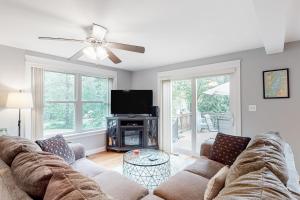a living room with a couch and a tv at Sheldrake Cove Retreat in Windham