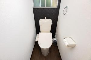 a small bathroom with a toilet and a window at Vacation Rental NISHIDA in Kagoshima