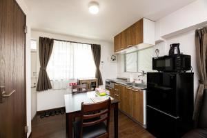 A kitchen or kitchenette at Vacation Rental NISHIDA