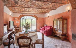 a living room with a table and a red couch at Podere La Carraia in San Donato in Fronzano