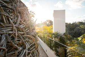 a pile of branches on a balcony with plants at Unique & Stylish Apartment With Lovely Decked Terrace & Awesome Floating Pool In Tulum in Tulum