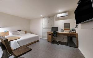 清州的住宿－HOTEL YaJa WestGate，一间卧室配有一张床和一张带电脑的书桌