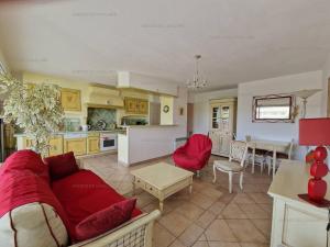 a kitchen and living room with a couch and a table at T3 au centre de Cavalaire avec parking, clim, wifi, proche plage - FR-1-100-272 in Cavalaire-sur-Mer +6 photos