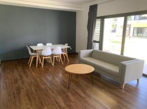a living room with a couch and a table at MF Roxy Beach Townhouse Sematan Private Unit L31 in Sematan