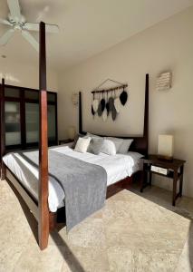 a bedroom with a bed with pots and pans on the wall at Amazing Luxury Penthouse with sunset,sunrise view, private Jacuzzi and rooftop pool in Tulum +52 photos