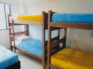 a couple of bunk beds in a room at Hostal Casa Lantana La Candelaria in Bogotá