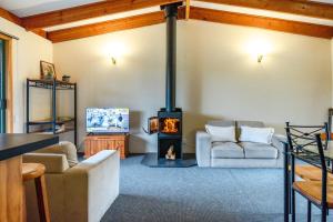 a living room with a wood stove in a room at Freycinet Cottage 2 – Dolerite in Coles Bay