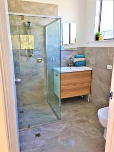 a bathroom with a shower and a sink at Kangaroo Island - Island Beach Shack in Island Beach