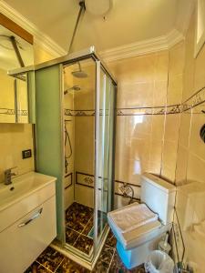 a bathroom with a shower and a sink at Mas Butik Otel in Edremit