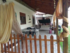 a porch with a wooden fence and a piano at Invest In Rest in Vourvourou