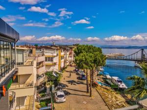 a view of a street in a city next to the water at Mas Butik Otel in Edremit