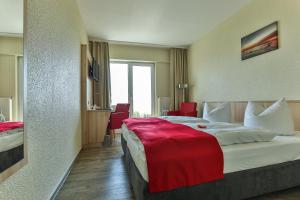 Rúm í herbergi á Rügen-Hotel