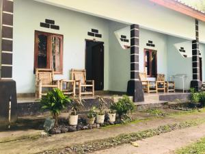a house with chairs and plants in front of it at Sawe Homestay in Kuta Lombok