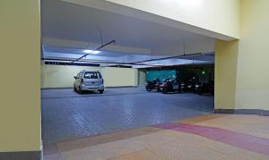 a parking garage with a car parked in it at Treebo Trend Lazystay Grand Patia in Bhubaneshwar